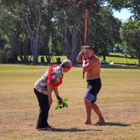 Visitor to Waitangi Marae responds to the wero (challenge) by bending to pick up the taki (in this case a branch) indicating to the people of the marae that his party comes in peace. Image: Su Leslie, 2017