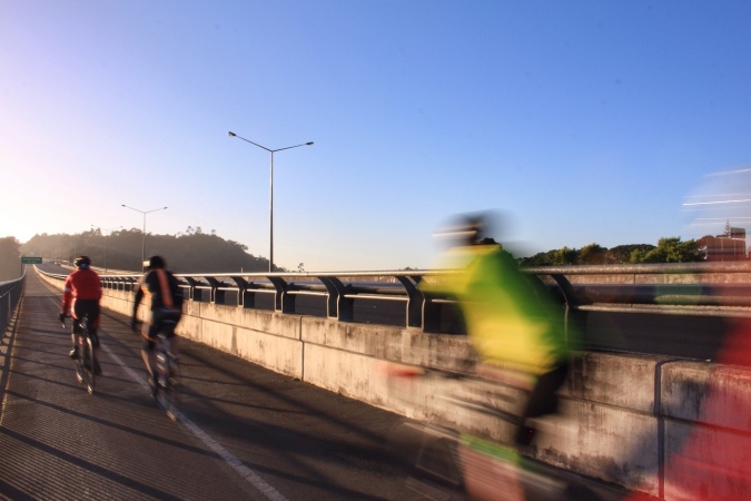Cyclists on Greenhithe Bridge, Auckland, NZ. Foreground riders blurred. Image: Su Leslie, 2017