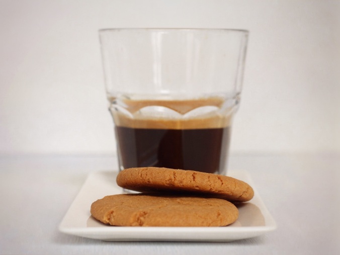 A snack for the journey. Closeup shot of two cookies and an expresso in a glass. Image: Su Leslie, 2017
