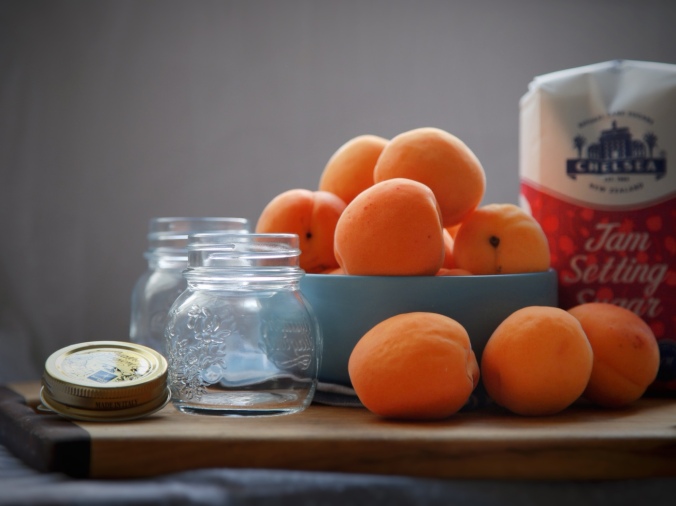 Close up shot of apricots in a bowl, two empty glass jars and a bag of jam setting sugar. Preparations for apricot jam-making. Image: Su Leslie, 2018
