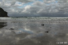Stormy beach, with clouds reflected in wet sand. Waihi Beach, NZ. Image: Su Leslie, 2018