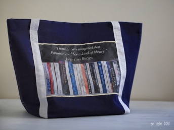 Blue and white tote bag, for carrying library books. Slogan says "I have always imagined that Paradise would be a kind of library." Jorge Luis Borges. Image: Su Leslie, 2018