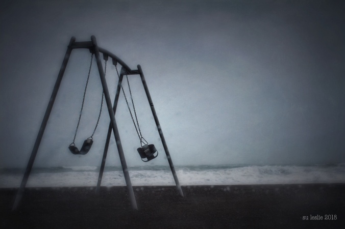 Playground swing set on beachfront during storm. Su Leslie 2018